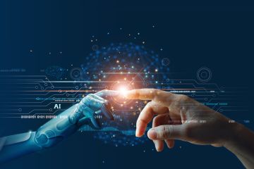 Implementation - Innovation - Future: Human hand touching robotic hand with glowing light symbolizing AI and technology connection.